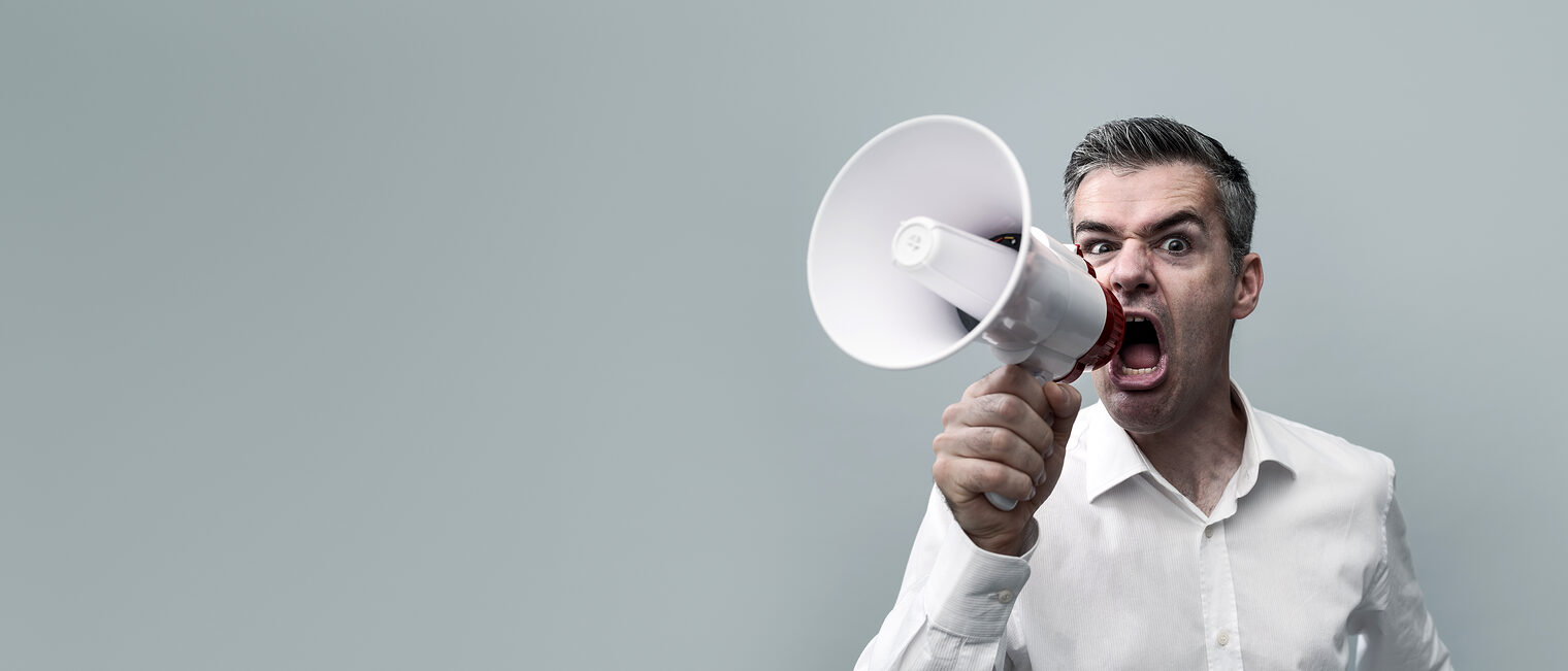 Aggressive man shouting with a megaphone and spreading his message, advertising and communication concept Schlagwort(e): Man, Shouting, Megaphone, Screaming, Loud, Advertising, Communication, Voice, Calling, Aggressive, Recruitment, Talking, Speech, Announcement, Expression, Caucasian, Angry, Businessman, Attention, Confident, Gesturing, Determination, Cheerful, Leader, Spread, Successful, Sharing, Speaker, Glasses, Marketing, Announce, Portrait, Shirt, Energy, Vitality, 40s, 30s