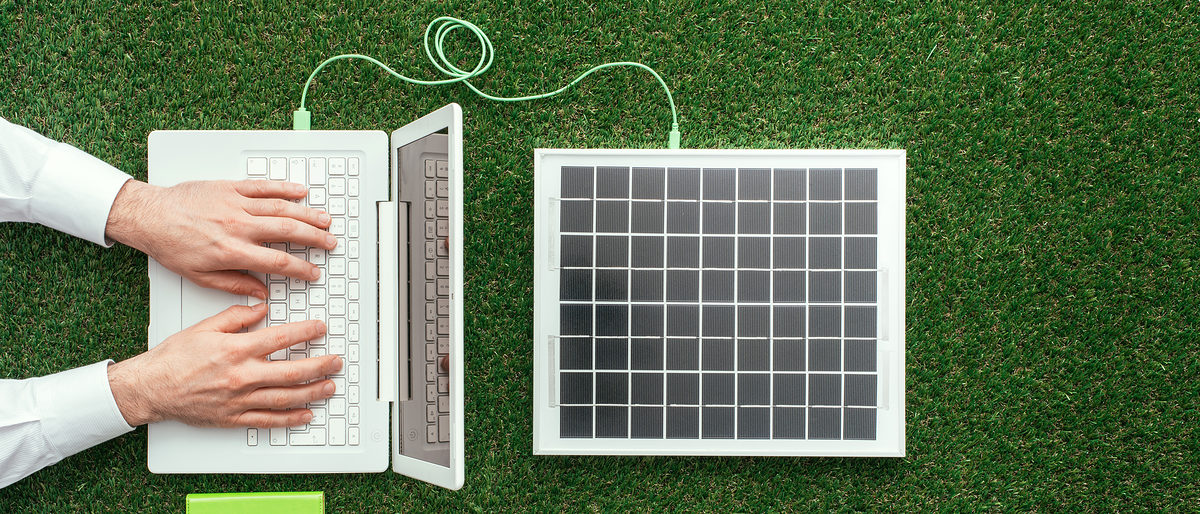 Man working with a laptop on the grass connected to a solar panel, alternative energy sources and electrical power generation concept Schlagwort(e): Laptop, Computer, Green, Solar panel, Power, Energy, Grass, Man, Businessman, Environment, Business, Ecology, Eco, Sustainable, Sustainability, Internet, Hands, Environmental care, Alternative energy, Innovation, Environmental conservation, Photovoltaic, Renewable, Resource, Clean, Recycling, Solar energy, Top view, Above, Working, Typing, Communication, Energy saving, Eco friendly, Connection, Electric, Electrical, Electricity, Meadow, Nature, Technology, Wifi, Wi-fi