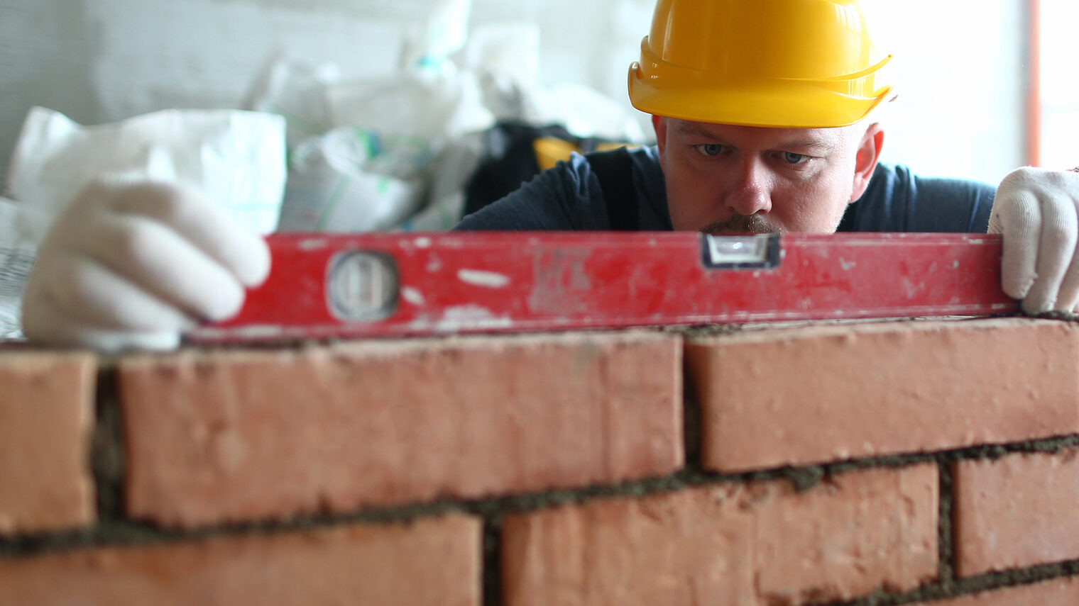 Portrait of hardworking male using level to stick to strict construction scale and put red bricks on concrete wall properly. Pedantic builder try to work right. Building concept Schlagwort(e): portrait, hardworking, stacker, man, builder, hardhat, male, use, level, stick, strict, construction, scale, put, red, bricks, concrete, wall, properly, try, work, right, building, concept, professional, skilled, bricklayer, focus, big, special, blocks, lay, unfinished, structure, materials, make, industry, site, engineer, brickwork, constructor, masonry, craftsman, job, architecture, measure, stonework, laborer, install, equipment, portrait, hardworking, stacker, man, builder, hardhat, male, use, level, stick, strict, construction, scale, put, red, bricks, concrete, wall, properly, try, work, right, building, concept, professional, skilled, bricklayer, focus, big, special, blocks, lay, unfinished, structure, materials, make, industry, site, engineer, brickwork, constructor, masonry, craftsman, job, architecture, measure, stonework, laborer, install, equipment