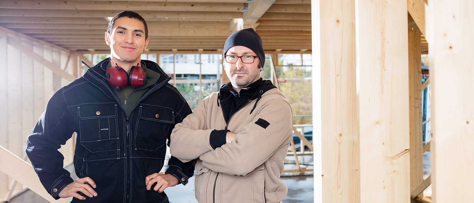 Auszubildender und Ausbilder auf der Baustelle. Bild: stock.adobe.com / Tyler Olson