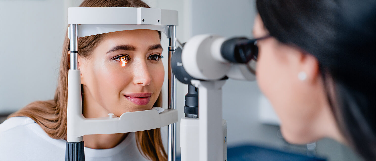 Eine Augenoptikerin misst das Sehvermögen einer Kundin.