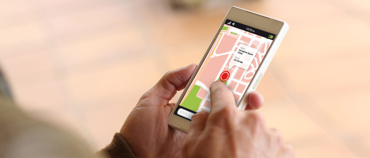man touching the screen of his smartphone showing gps app. All screen graphics are made up. Schlagwort(e): gps, map, hand, google, apps, business, sign, digital, editorial, technology, crossing, motorway, surfing, mobile, touchscreen, group, tagged, smartphone, using, device, online, wireless, logo, screen, junction, icons, crossroads, advertise, media, illustrative, bright, internet, location, circle, highway, cellphone, lifestyle, brand, holding, connect, track, application, play, phone, lviv, road, communication