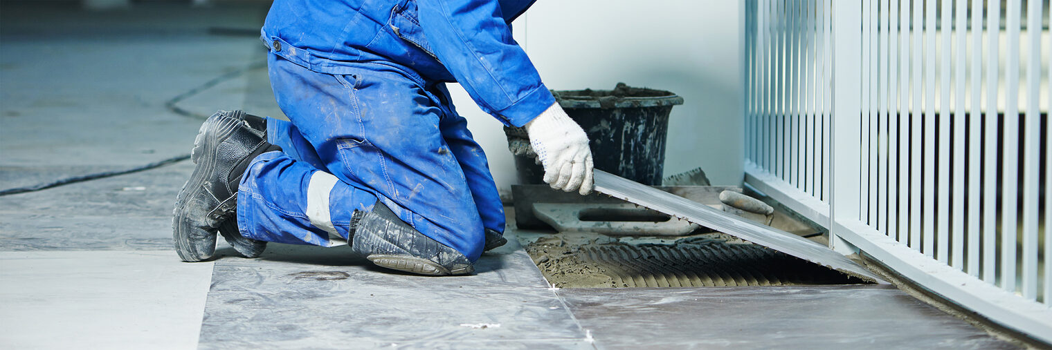 industrial tiler builder worker installing floor tile at repair renovation work Schlagwort(e): flooring, renovation, man, laying, tile, tiling, tiler, trowel, mortar, plaster, plastering, worker, builder, cement, ceramic, construction, contractor, male, fix, handyman, indoor, interior, material, modern, overhaul, professional, spacer, tool, workshop, laborer, labor, apartment, caucasian, decorating, decoration, improvement, master, renewal, repair, repairman, residential, restoration, work, workplace, industrial, tiling work, floor, serviceman, tile cutter