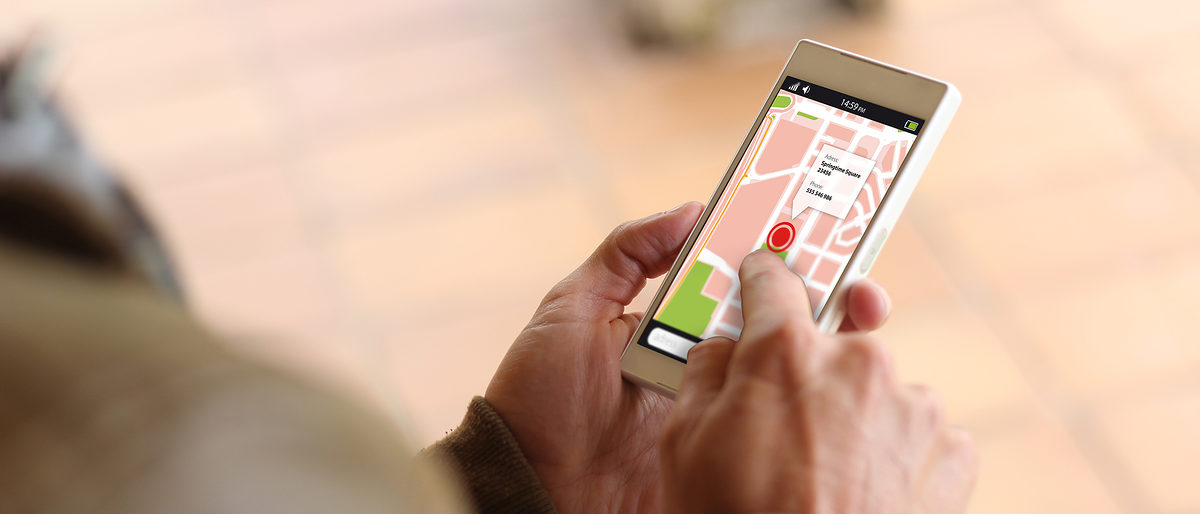 man touching the screen of his smartphone showing gps app. All screen graphics are made up. Schlagwort(e): gps, map, hand, google, apps, business, sign, digital, editorial, technology, crossing, motorway, surfing, mobile, touchscreen, group, tagged, smartphone, using, device, online, wireless, logo, screen, junction, icons, crossroads, advertise, media, illustrative, bright, internet, location, circle, highway, cellphone, lifestyle, brand, holding, connect, track, application, play, phone, lviv, road, communication